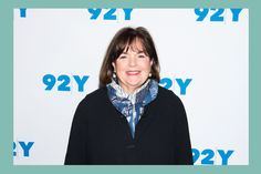 a woman standing in front of a blue and white background with the number 922y on it