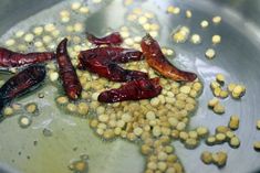 red peppers and corn are being cooked in a pan