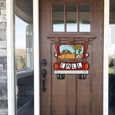 the front door is decorated with an image of a truck and pumpkins