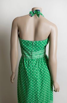 "FREE DOMESTIC SHIPPING! <3 ♥ Lovely vintage 1970s green & white floral print halter maxi dress! ♥ Nylon zipper in the back. Halter tie at the back of the neck. Open back! ♥ Long maxi floor length. Tiered style skirt. Sweet floral print in white! ♥ The reverse side on the bodice is in blue! A little pop of it shows with the halter tie in back! ♥ In great condition! No label tag, handmade most likely. Cotton! * measurements * Bust - 36\" Waist - 27\" Hips - 44\" Bodice length - 14\" to top Green Lined Halter Neck Dress, Green Halter Neck Lined Dress, Fitted Green Maxi Dress For Daywear, Green Sundress Maxi Dress For Daywear, Green Sundress Maxi For Daywear, Vintage Green Maxi Dress For Summer, Green Vintage Maxi Dress For Summer, Vintage Green Spring Maxi Dress, Vintage Green Maxi Dress For Spring