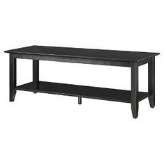 a black table sitting on top of a white wall