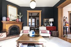 a living room with black walls and white furniture