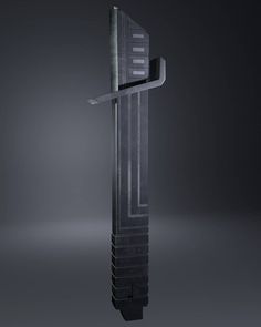 a tall black object with a long metal bar on it's side, in the middle of a dark room