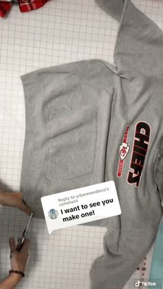 someone is cutting out the back of a grey hoodie that says, i want to give you make one