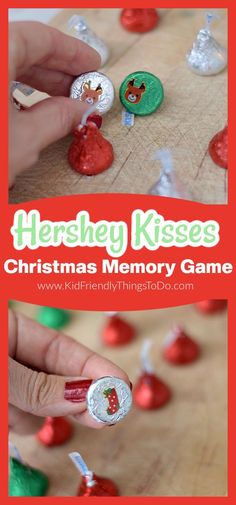 a hand holding a christmas memory game with hershey kisses on it and candy in the background