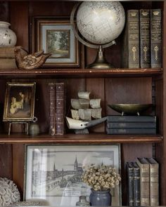 a book shelf filled with books and pictures