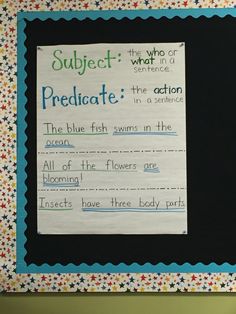 a piece of paper taped to a blackboard with writing on it that says subject predicate the blue fish swims in the ocean all of the flowers are blooming