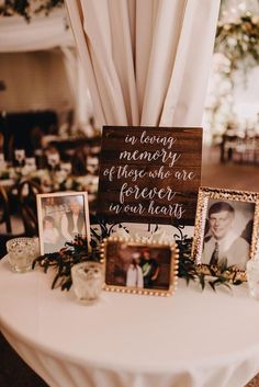 a table topped with pictures and framed photos next to a sign that says in loving memory of those one forever in our hearts