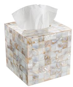 a tissue box that is made out of mother of pearl tiles and has a roll of tissue in it