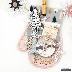 an altered christmas card with paper snowflakes and other holiday decorations on it,