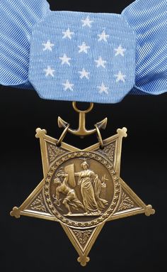 an award medal with a blue ribbon around it and a gold star on the front