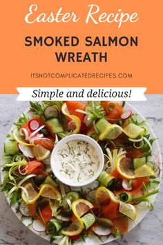 a plate filled with smoked salmon, lettuce and carrots next to a bowl of ranch dressing