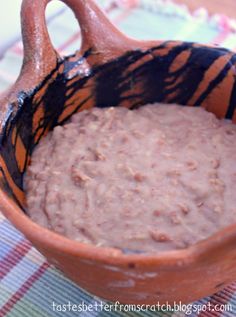 a bowl filled with oatmeal sitting on top of a checkered table cloth