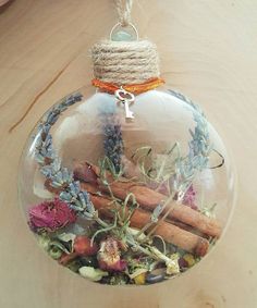 a glass ornament filled with dried flowers and herbs