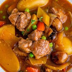 a white bowl filled with meat and vegetables