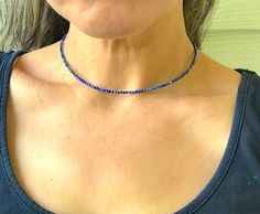 A minimalist necklace made with rich blue beads of genuine lapis lazuli. These AAA quality stones measure 2mm in diameter, and they are round with multifaceted cuts that give them a little extra shimmer in the light. There is a small silver bead at each end, and this connects with a sterling silver lobster claw clasp in the back. Available in a variety of lengths, and comes packaged in a small gift box for you. Ships in 1 business day, via USPS ground advantage. Blue Tiny Beads Round Jewelry, Blue Gemstone Beaded Minimalist Necklace, Blue Round Jewelry With Tiny Beads, Minimalist Blue Gemstone Beaded Necklaces, Minimalist Blue Jewelry With Tiny Beads, Minimalist Blue Gemstone Beaded Necklace, Dainty Blue Faceted Necklace, Blue Single Strand Minimalist Beaded Necklaces, Blue Lapis Lazuli Jewelry With Faceted Beads