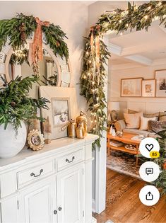 a living room decorated for christmas with greenery on the mantle and decorations around it