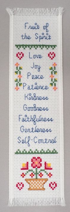 a cross stitched wall hanging with the words, fruit of the spirit and love