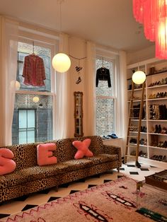 a living room filled with furniture and lots of windows