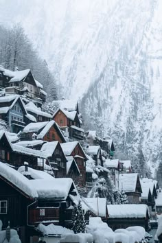 snow covered houses on the side of a mountain