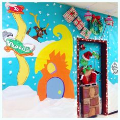 a room decorated for christmas with santa's sleigh and grino on the wall