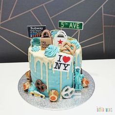 a birthday cake decorated with various items and the words i love new york on it