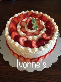 there is a cake that has strawberries on it and the words lonni's written in white