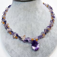 "DESCRIPTION: Thank you for coming in! A breath-takingly beautiful necklace made of an assortment of natural gemstones! You can find Iolite, Amethyst, sunstone and peach moonstone in this one necklace! Premium quality gemstones finished with gold filled headpins and 18k solid yellow gold clasp! 17\" gorgeous necklace, 186.9 carats! You'll get the necklace you see! SIZE: 14.7mmx23.5mm center stone. GRADE: Transparent COLOR: Multi" Teardrop Amethyst Necklaces With Gemstone Accents, Purple Briolette Gemstone Crystal Necklace, Amethyst Briolette Necklace With Gemstone Accents, Briolette Amethyst Natural Stone Gemstones, Amethyst Briolette Necklace For Jewelry Making, Multi-stone Amethyst For Jewelry Making, Teardrop Amethyst Gemstone Beads Necklaces, Amethyst Multi-stone Briolette Gemstones, Amethyst Briolette Multi-stone Gemstones