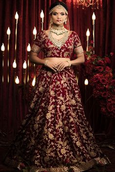 Wedding lehenga choli in maroon royal velvet fabric. Maroon velvet fabric Lengha choli with Zardozi embroidery. Sabyasachi inspired lehenga choli. Sweetheart neck Velvet lengha choli with sequins handwork. Extravagant gold threaded Marodi zardozi as well as Ari work of floral motif runs all over this lehenga. Simple net dupatta with sequins handwork. #weddinglehenga2021 #maroonlehengacholi #bridallengha #zardoziembroidery #ariembroiderylehenga #velvetlehengacholi #sequinswork #sabyasachiinspired Sabyasachi Maroon Lehenga, Festive Chandbali Gown For Reception, Wedding Choli With Resham Embroidery And Kundan, Festive Kundan Choli With Traditional Drape, Navratri Lehenga With Intricate Kundan Embroidery, Festive Kundan Gown For Navratri, Festive Gown For Navratri, Festive Choli With Intricate Embroidery For Transitional Season, Chandbali Traditional Wear With Intricate Embroidery For Diwali