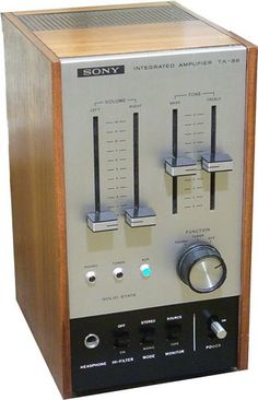 an old fashioned radio sitting on top of a wooden stand with buttons and knobs