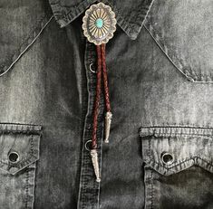 John Dutton, this one's for you, although you might find Jamie rooting through you drawers to borrow it! Our Sun Flower Turquoise Concho Southwestern Bolo Tie is handmade using silver and turquoise. The cord is genuine brown leather.A great gift for any Cowboy, Cowgirl, Bolo Tie, Rodeo, Yellowstone TV, or 1883 Series Lovers. Though Bolo ties are no longer limited to Western world, they're worn by stylish The western bolo tie rope length is 40'' Turquoise pendant measures 2'' x 1-1 /2"Proudly mad Bohemian Concho Bolo Ties For Rodeo, Bohemian Silver Bolo Ties For Western-themed Events, Silver Bohemian Bolo Ties For Western-themed Events, Silver Bohemian Bolo Tie For Western-themed Events, Bolo Tie Men, Western Bolo Tie, Cowboys And Indians, Bolo Tie, Southwestern Style