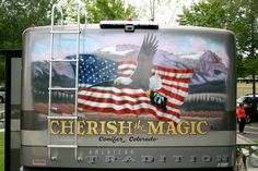 the back of a bus with an eagle and flag painted on it's side