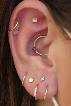 a close up of a person with ear piercings on their left and right sides