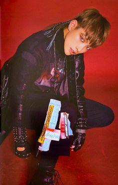 a young man kneeling down with some candy in his hand