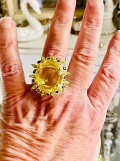 This is a beautiful one of a kind hand crafted artisan style huge lemon quartz ring. Size 9. It features a beautiful authentic 35+ karat sparkly shiny yellow lemon quartz. Surround by smaller green peridot. They are fashioned in sterling silver. This beauty is heirloom quality. Luxury Yellow Gemstones With Accent Stones, Luxury Round Yellow Gemstones, Luxury Yellow Round Gemstones, Luxury Yellow Citrine Gemstones, Yellow Gemstones With Accents Fine Jewelry, Unique Citrine Rings With Gemstone Accents, Luxury Yellow Rings For Collectors, Yellow Citrine Gemstones With Accents, Luxury Faceted Yellow Ring