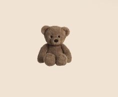 a brown teddy bear sitting in the air