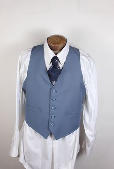 "ALL CLOTHING SALES ARE FINAL. How sharp is this vest, though? Wow. And guess what? It's reversible! Two vests in one. The one side is blue with two pockets, and the reverse is blue plaid. No smoke, damage or mildew. No tags. 36R chest. Measurements:  Chest: 36\" Length: 24\" Pair with many of the handsome ties available in the shop right now and save on shipping! I'm here to make you look good. What a fun item! Thank you for looking!" Vintage Fitted Sleeveless Outerwear, Fitted Sleeveless Vintage Outerwear, Retro Fitted Sleeveless Outerwear, Retro Sleeveless Vest With Pockets, Vintage Blue Sleeveless Outerwear, Fitted Vintage Blue Vest, Blue Fitted Vintage Vest, Classic Blue Cotton Vest, Retro Fitted Sleeveless Vest