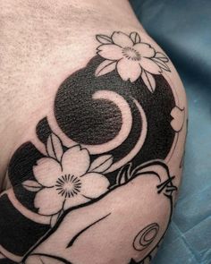 a close up of a person's arm with flowers on it and an elephant