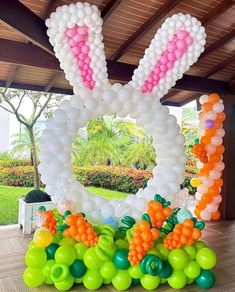 an easter decoration made out of balloons in the shape of a letter o and bunny ears