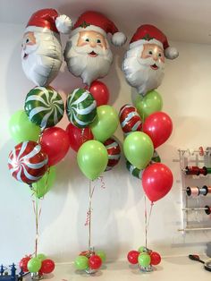 christmas balloons and santa clause heads hanging on the wall