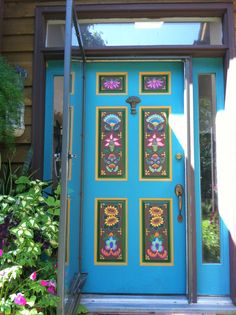 a blue front door with four pictures on it