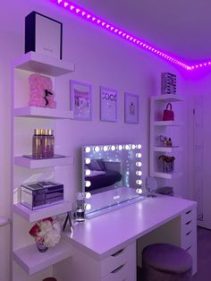 a white desk topped with a vanity mirror and lots of purple lights in a room