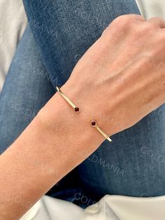 All Our Bracelets Are Made Of REAL 14K GOLD  14K Yellow Gold 3mm Round Garnet Open Cuff Bangle Bracelet, Real Gold Bangle, Women  Shop our 14K Bracelets https://www.etsy.com/shop/GOLDMANIA?ref=seller-platform-mcnav§ion_id=26925987  Shop On Sale items https://www.etsy.com/shop/GOLDMANIA?ref=seller-platform-mcnav§ion_id=1  Metal: 14K Yellow Gold   Width: 2 MM  Length: 7 IN  Closure:  Weight: 3.30 Gram   Gemstone size: 3mm Also available with Peridot, Citrine, Blue Topaz And Amethyst   SHIPPED FROM Classic Gold Bangle With Gemstone, Yellow Gold Open Cuff Jewelry Gift, Yellow Gold Open Cuff Bangle For Gift, Yellow Gold Open Cuff Bangle As Gift, Elegant Gold Bangle With Birthstone, Gold Bangle Bracelet With Birthstone, Gold Bangle With Birthstone, Cuff Bangle Bracelet, Gold Bangle