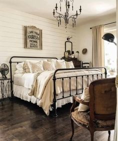 a bedroom with white walls and wood floors