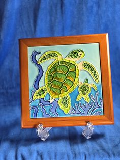 a painting of a sea turtle on a wooden frame with acrylic paint applied to it