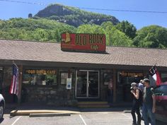 people are standing outside the old rock cafe