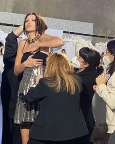 a group of women standing around each other