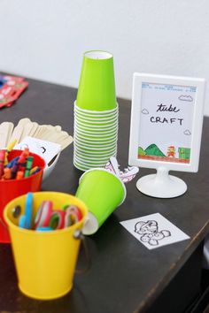 the table is set up with cups and markers