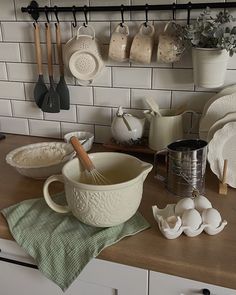 the kitchen counter is clean and ready to be used for baking or serving dishes with utensils on it