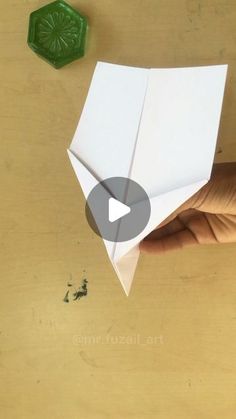 someone is holding an origami piece in their hand